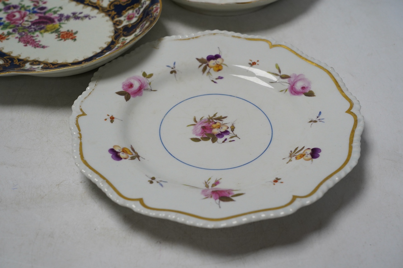 An 18th century Worcester dessert dish and two later Barr Flight & Barr plates, larger 26cm. Condition - worn